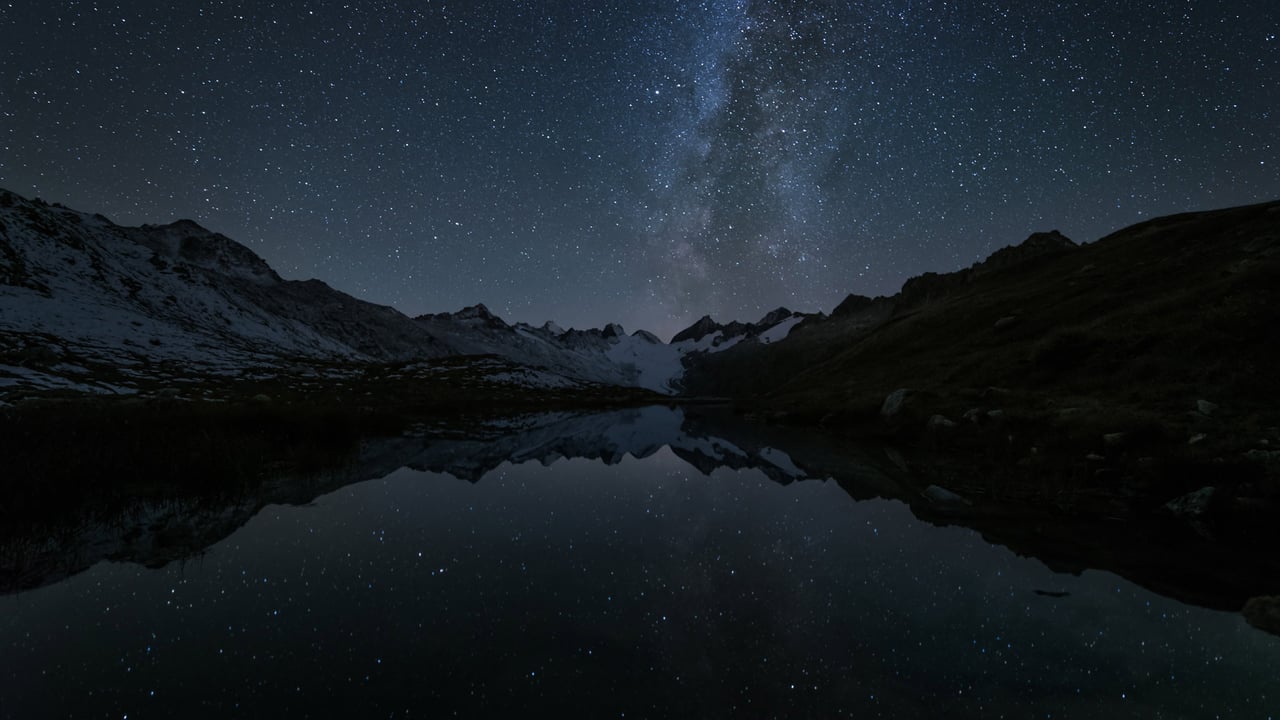 Stars reflected in the Totensee, a mountain lake at Grimsel Pass, Switzerland (© magodevita/Getty Images)