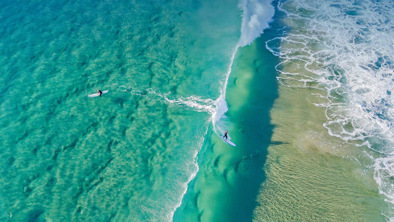Surfers catching waves at Palm Beach on the Gold Coast, Queensland, Australia (© Darren Tierney/Getty Images)