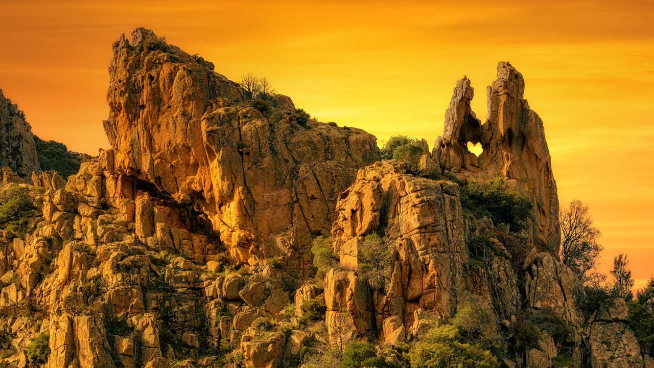 A heart-shaped hole in the rock formation of Calanques de Piana in Corsica, France (© joningall/Getty Images)