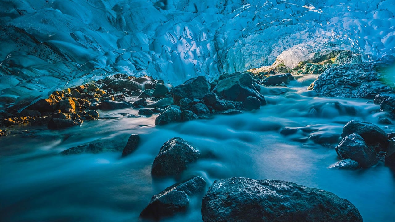 Flowing river inside a glacier cave, Vatnajökull, Iceland (© Marco Bottigelli/Getty Images)