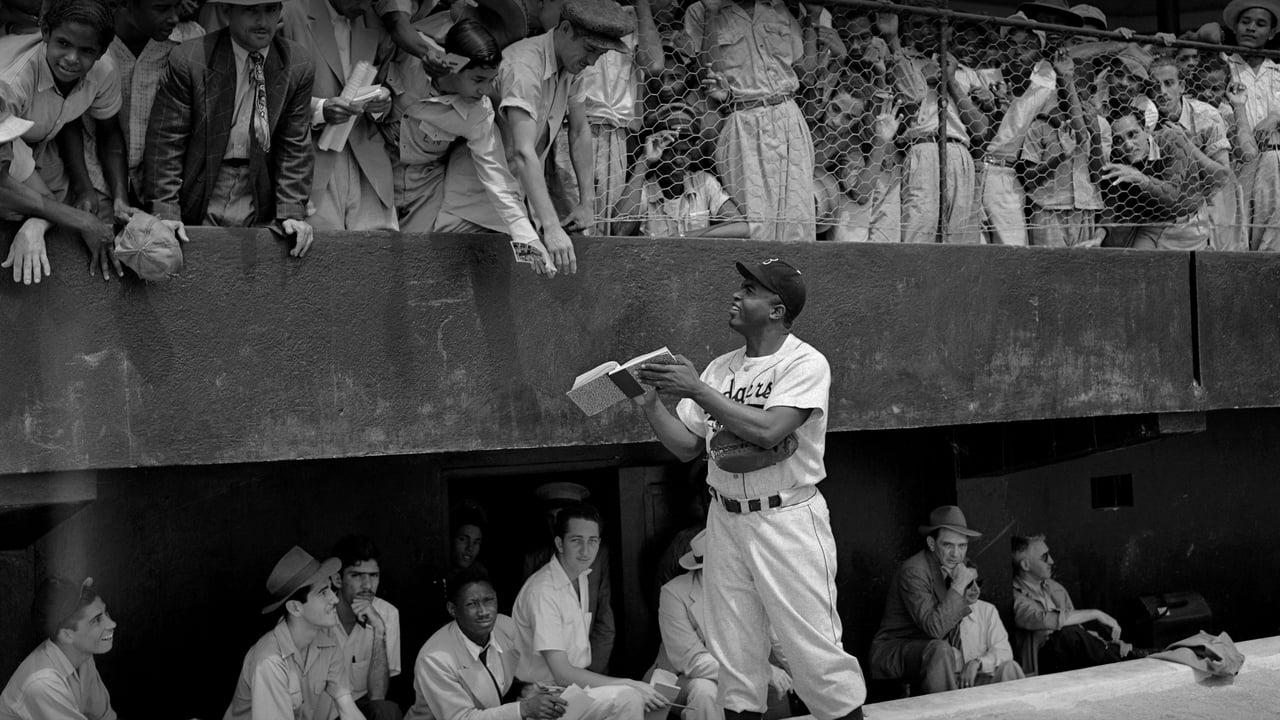 Jackie Robinson signs autographs at spring training in Ciudad Trujillo, now Santo Domingo, Dominican Republic, on March 6, 1948 (© Bettmann/Getty Images)