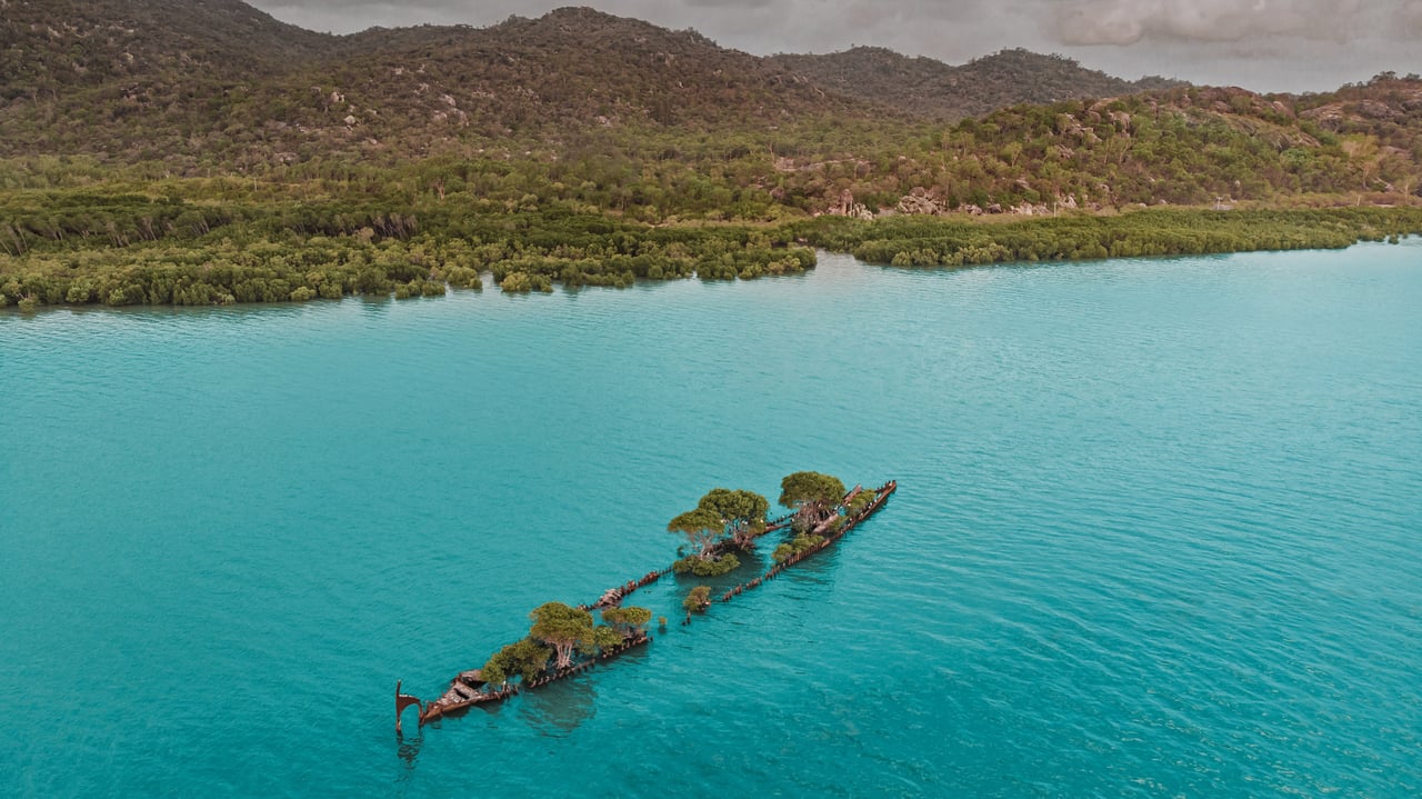 Aerial view of the City of Adelaide shipwreck with trees growing on it, Magnetic Island, Queensland, Australia (© Amazing Aerial Agency/Offset by Shutterstock)