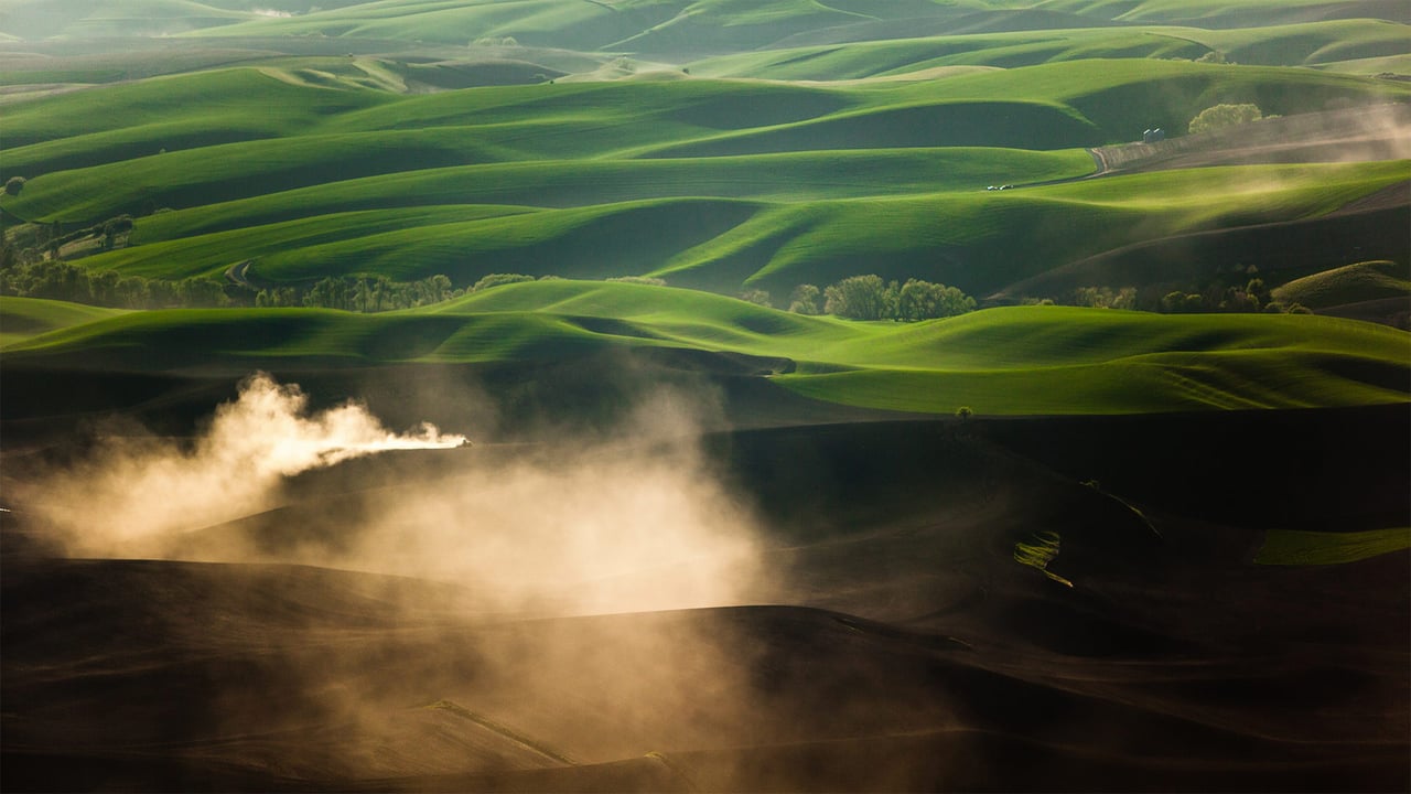 A tractor kicks up dust while tilling fields on the Palouse near Pullman, Washington (© Ben Herndon/Tandem Stills + Motion)