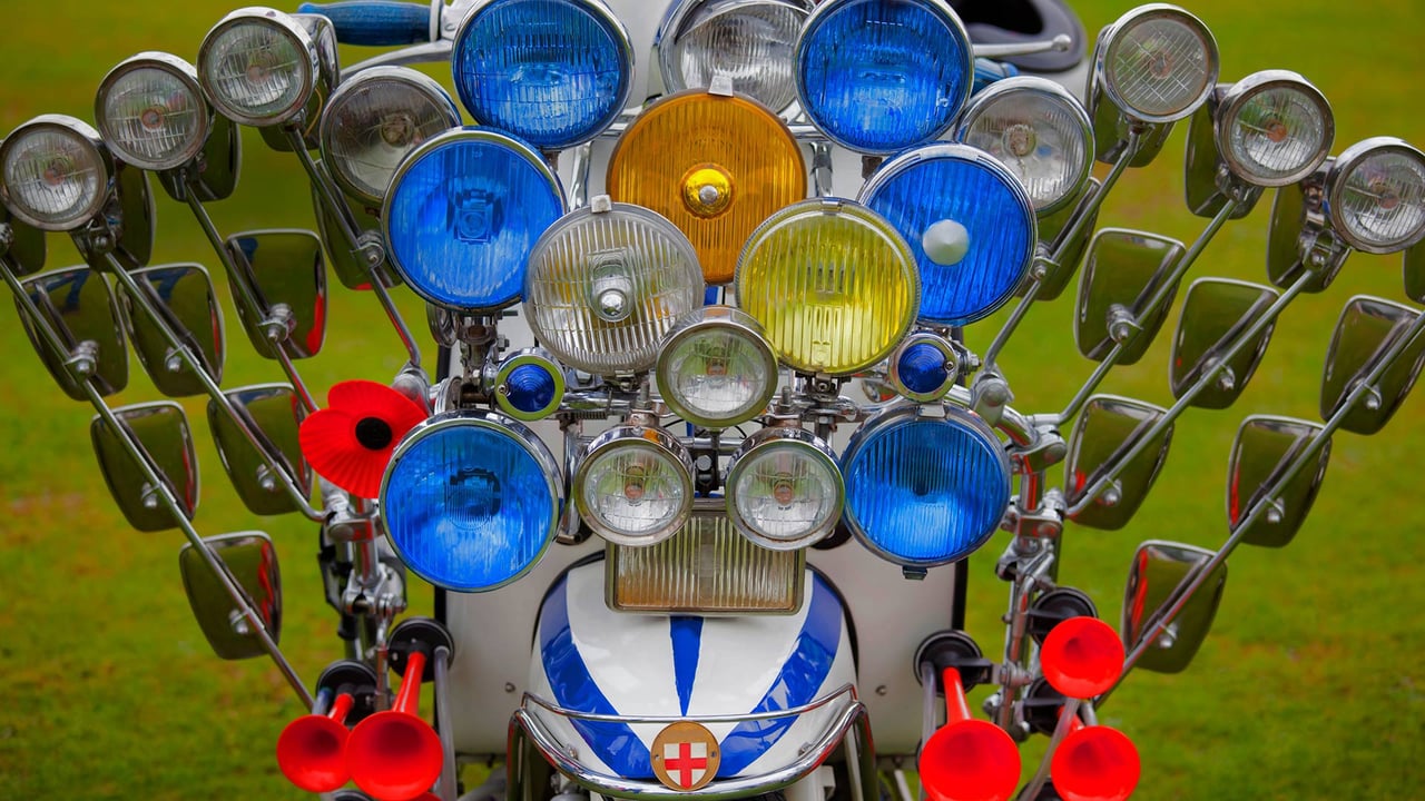 A scooter adorned with multiple mirrors, lights, and air horns (© stocknshares/Getty Images)