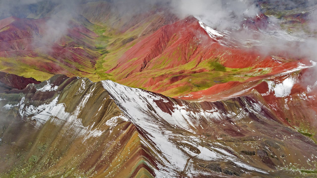 Aerial view of snowy peaks of Vinicunca (aka Rainbow Mountain), Peru (© Jude Newkirk/Amazing Aerial Agency)