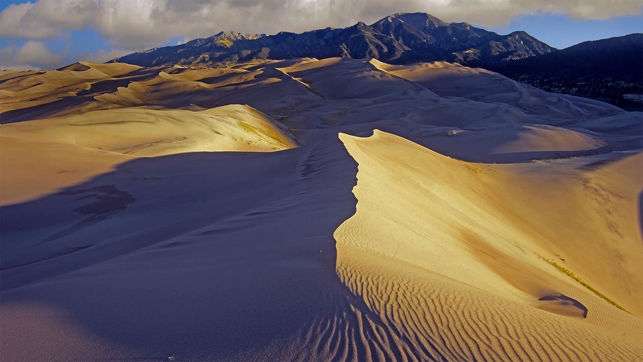 Sand dunes with Sangre de Cristo Mountains in the background, Great Sand Dunes National Park and Preserve, Colorado (© Tim Fitzharris/Minden Pictures)