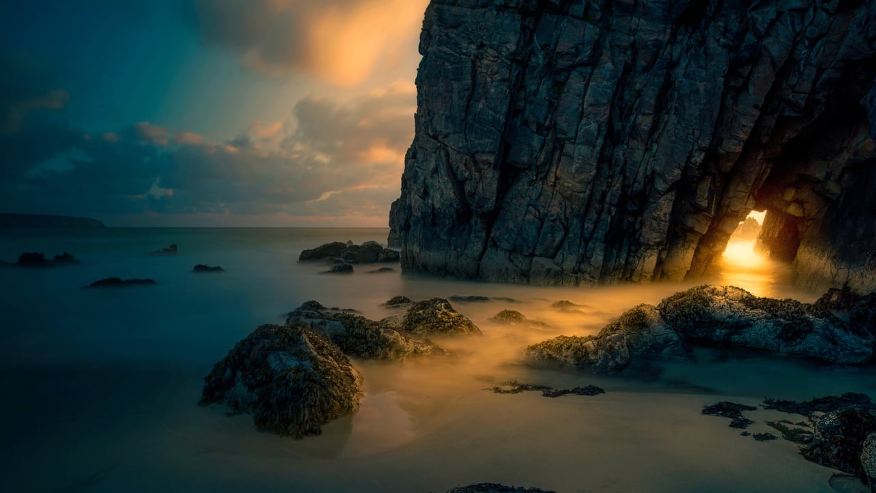 Light from sunrise through a sea cave on the Isle of Skye, Scotland (© Luca Benini/PLM Collection/Offset)