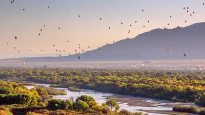 Bing wallpaper January 9, 2024. Hot air balloons over the Rio Grande, Albuquerque, New Mexico (© Jennifer MacCornack/Shutterstock)