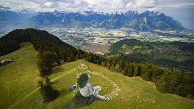 Bing wallpaper November 20, 2024. Giant land art painting 'Beyond Crisis' by Saype, Leysin, Switzerland (© VALENTIN FLAURAUD/EPA-EFE/Shutterstock)