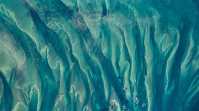 Bing wallpaper January 28, 2023. Blue-green waters around the Bahamas as seen from the International Space Station (© NASA)