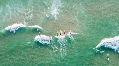 Bing wallpaper June 19, 2021. People surfing at Burleigh Heads, Gold Coast, Australia (© Vicki Smith/Getty Images)
