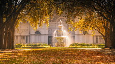 Bing wallpaper May 10, 2020. Carlton Gardens fountain and autumn trees catching the sunlight in front of the Royal Exhibition Building, Melbourne (© CBCK-Christine/iStock/Getty Images Plus)