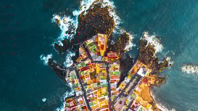 Bing wallpaper February 18, 2024. Aerial view of colourful houses on a headland in Puerto de la Cruz, Tenerife, Spain (© Marco Bottigelli/Getty Images)