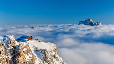 Bing wallpaper February 20, 2020. Rifugio Lagazuoi above the clouds with Monte Pelmo in the background, Dolomites, Italy (© Nicolo Miana/eStock Photo)
