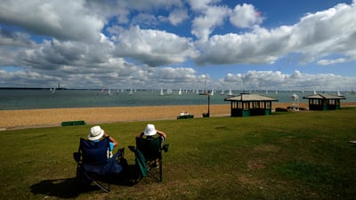 Bing wallpaper August 1, 2025. Spectators at Cowes Week 2013 in Cowes, Isle of Wight (© Alan Crowhurst/Getty Images)