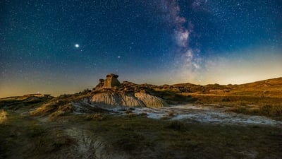 Bing wallpaper July 16, 2024. Summer Milky Way over the badlands formations at Dinosaur Provincial Park, Alberta, Canada (© Alan Dyer/Stocktrek Images/Getty Images)