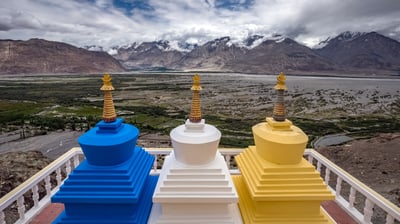 Bing wallpaper March 12, 2021. Three stupa with Nubra Valley in the background in Ladakh, India (© Puripat Lertpunyaroj/Getty Images)