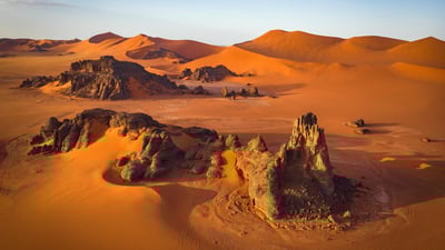 Bing wallpaper August 31, 2024. Rock formations and sand dunes in the Sahara, Tassili n’Ajjer, Algeria (© Airpano/Amazing Aerial Agency)