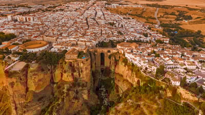 Bing wallpaper November 13, 2021. Aerial view of El Tajo gorge and the Puente Nuevo bridge in Ronda, Málaga, Spain (© Jude Newkirk/Amazing Aerial Agency)