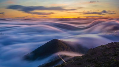 Bing wallpaper April 6, 2020. Flowing clouds over the Atlantic Ocean and Tenerife mountains, Canary Islands, Spain (© MikeMareen/iStock/Getty Images Plus)