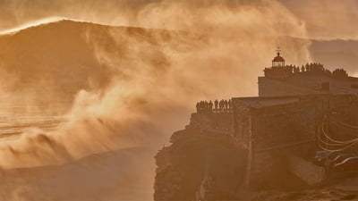 Bing wallpaper January 7, 2022. Nazaré Lighthouse atop Forte de São Miguel Arcanjo, Nazaré, Portugal (© Richard A Lock/Getty Images)