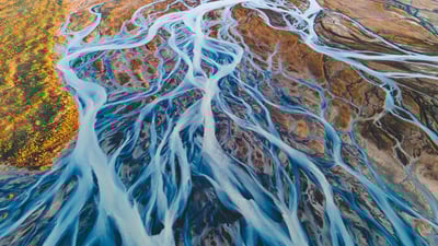 Bing wallpaper November 8, 2024. Aerial view of glacial rivers in Iceland (© rybarmarekk/Shutterstock)