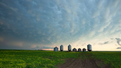 Bing wallpaper July 17, 2026. A prairie storm gathers over grain silos in Saskatchewan (© mysticenergy/Getty Images)