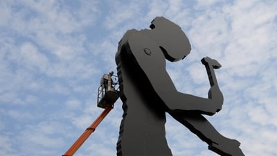 Bing wallpaper September 7, 2020. A worker painting the Hammering Man, a sculpture by Jonathan Borofsky, in Frankfurt, Germany (© Arne Dedert/Alamy)