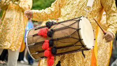 Bing wallpaper January 12, 2022. Musician playing a traditional Indian dhol (© Nelson Art/Alamy Stock Photo)