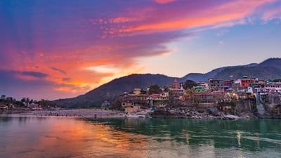 Bing wallpaper June 20, 2026. Colourful sky and clouds reflecting over the Ganges River, Rishikesh (© fbxx/iStock/Getty Images)
