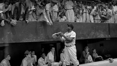 Bing wallpaper April 15, 2021. Jackie Robinson signs autographs at spring training in Ciudad Trujillo, now Santo Domingo, Dominican Republic, on March 6, 1948 (© Bettmann/Getty Images)