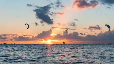 Bing wallpaper August 24, 2026. Kitesurfer bei Sonnenuntergang in Deutschland (© Jens Breuer/Getty Images)