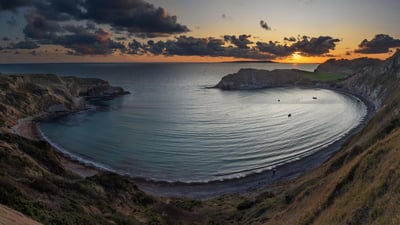 Bing wallpaper August 17, 2020. Panoramic view of Lulworth Cove at sunset in Dorset, England (© Adrian Baker/Shutterstock)
