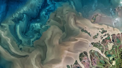 Bing wallpaper September 26, 2021. The Mackenzie River in Canada emptying into the Beaufort Sea (© Norman Kuring, GSFC/NASA/USGS Landsat)