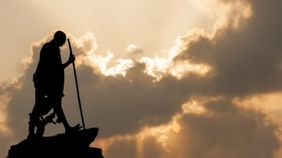 Bing wallpaper October 1, 2023. Mahatma Gandhi statue in Chennai at sunset with dramatic sky (© cornfield/Shutterstock)