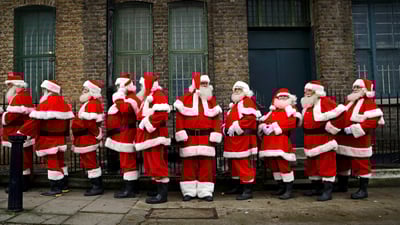 Bing wallpaper December 20, 2021. Performers from the Ministry of Fun Santa School in London, England (© Matt Dunham/AP Photo)