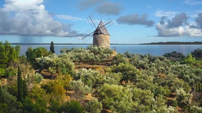 Bing wallpaper May 4, 2022. Ancient stone windmill, France (© Damocean/iStock/Getty Images Plus)