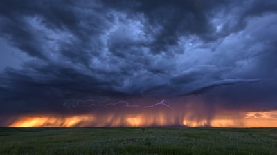 Bing wallpaper March 23, 2025. Lightning and storm clouds at sunset near Bowman, Nebraska (© john finney photography/Getty Images)