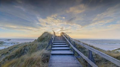 Bing wallpaper September 12, 2023. North Sea at sunset, Norddorf, Amrum Island, Germany (© Frederick Doerschem/Getty Images)
