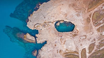Bing wallpaper June 1, 2021. Aerial view of the Grotta della Poesia (Poetry's Cave) near Roca, Lecce, Italy (© Amazing Aerial Agency/Offset by Shutterstock)