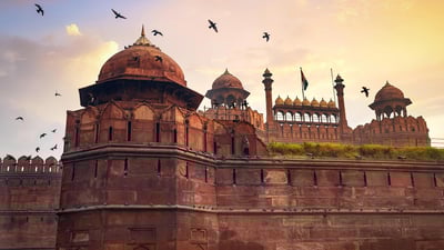 Bing wallpaper December 21, 2023. Red Fort Delhi historic monument at sunrise with flying pigeons (© Roop Dey/Alamy Stock Photo)