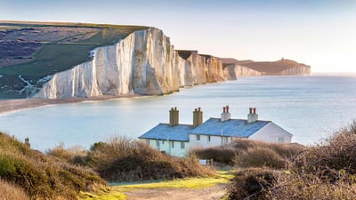 Bing wallpaper February 8, 2022. Coastguard cottages on Seven Sisters cliffs, East Sussex, England (© Paul Daniels/Alamy)