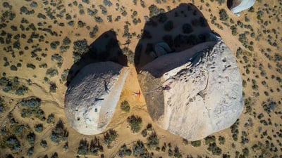 Bing wallpaper August 30, 2019. Slacklining between giant boulders in Bishop, California, USA (© Evgeny Vasenev/Aurora Photos)