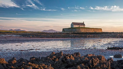 Bing wallpaper February 9, 2022. St Cwyfans Church, Anglesey at low tide. (© David Henderson/DEEPOL by plainpicture)