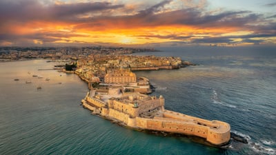 Bing wallpaper July 6, 2026. Syracuse at sunset, Sicily, Italy (© Balate Dorin/Getty Images)