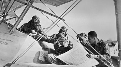 Bing wallpaper March 22, 2021. Tuskegee Airmen reading a map (© Bettmann/Getty Images)