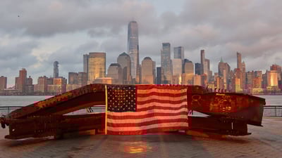 Bing wallpaper September 11, 2021. US flag on part of a 9/11 memorial overlooking the New York skyline from Exchange Place, Jersey City, New Jersey (© Gary Hershorn/Getty Images)