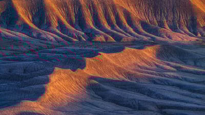 Bing wallpaper April 2, 2025. Sandstone formations in the badlands near Caineville, Utah (© Chris Moore/TANDEM Stills + Motion)