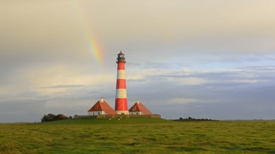 Bing wallpaper March 14, 2021. Regenbogen über dem Leuchtturm Westerheversand, Westerhever, Schleswig-Holstein (© Sandra Bartocha/Minden Pictures)