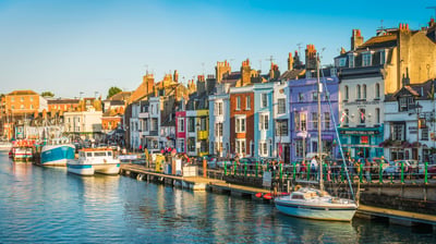 Bing wallpaper August 26, 2021. Colourful cottages, fishing boats and yachts around the harbour in Weymouth, Dorset (© fotoVoyager/Getty Images)